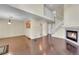 Open-concept living area with dark wood floors, fireplace, and staircase leading to the upper level at 4006 E Geddes Cir, Centennial, CO 80122