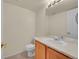 Powder room featuring a vanity with wood cabinets, a sink and a toilet at 4006 E Geddes Cir, Centennial, CO 80122