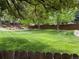 Spacious backyard with lush green grass, mature trees, and privacy fence at 5479 E Weaver Ave, Centennial, CO 80121