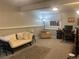 Carpeted basement area with a futon, work station, and ample space for relaxing and working at 5479 E Weaver Ave, Centennial, CO 80121