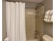 This bathroom features a neutral color scheme and a shower with a white curtain at 5479 E Weaver Ave, Centennial, CO 80121