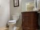 Cozy powder room featuring a single antique vanity with a marble countertop and decorative hardware at 5479 E Weaver Ave, Centennial, CO 80121