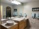 Spacious primary bath with double sinks, marble countertops, and decorative tile flooring at 5479 E Weaver Ave, Centennial, CO 80121
