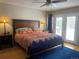 Bedroom featuring a queen-sized bed with a colorful comforter, wood floors and access to a private balcony at 5479 E Weaver Ave, Centennial, CO 80121