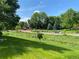 Scenic community park with walking path, mature trees, and lush green space on a sunny day at 5479 E Weaver Ave, Centennial, CO 80121
