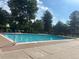 Inviting community pool with clear blue water, surrounded by a spacious deck and mature trees at 5479 E Weaver Ave, Centennial, CO 80121