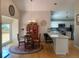 Open concept dining room with hardwood floors, modern lighting, and seamless flow into the kitchen at 5479 E Weaver Ave, Centennial, CO 80121