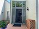 Elegant home featuring a stylish front door with glass detailing, flanked by decorative planters and modern lighting at 5479 E Weaver Ave, Centennial, CO 80121