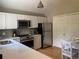 Modern kitchen features white cabinets, stainless steel appliances, stylish backsplash, and light countertop at 5479 E Weaver Ave, Centennial, CO 80121