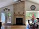 Bright living room features a tile fireplace, hardwood floors, and sliding doors to the outdoor deck at 5479 E Weaver Ave, Centennial, CO 80121