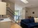 Cozy living room featuring hardwood floors, staircase with wrought iron railings, and neutral paint at 5479 E Weaver Ave, Centennial, CO 80121