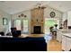 Bright living room featuring a fireplace, hardwood floors, and access to a deck at 5479 E Weaver Ave, Centennial, CO 80121