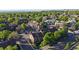 Aerial view of community with surrounding neighborhood, streets, and mature trees at 12360 W Nevada Pl # 101, Lakewood, CO 80228