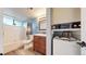 Bathroom showcasing a tub, modern vanity, toilet, and stacked washer/dryer at 12360 W Nevada Pl # 101, Lakewood, CO 80228