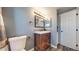 Updated bathroom featuring a wood vanity, decorative mirror, and updated fixtures at 12360 W Nevada Pl # 101, Lakewood, CO 80228