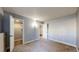 Bedroom with neutral walls, carpet, closet and access to another room at 12360 W Nevada Pl # 101, Lakewood, CO 80228