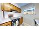 Kitchen with wood cabinetry, sleek black appliances, and a view to the living area at 12360 W Nevada Pl # 101, Lakewood, CO 80228
