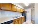 Kitchen featuring light wood cabinets, black appliances, and a double stainless sink at 12360 W Nevada Pl # 101, Lakewood, CO 80228
