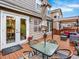 Outdoor dining area on a wooden deck with a glass table at 9774 Burberry Way, Highlands Ranch, CO 80129