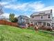 A beautiful backyard featuring a wooden deck, well-maintained lawn, and a trampoline at 9774 Burberry Way, Highlands Ranch, CO 80129
