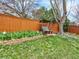 Backyard garden swing on a meticulously maintained lawn at 9774 Burberry Way, Highlands Ranch, CO 80129