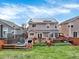 A spacious backyard featuring a deck, lawn, trampoline, and solar panels at 9774 Burberry Way, Highlands Ranch, CO 80129