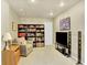 Finished basement area with plush carpeting, equipped with a large TV, bookcase, and comfortable seating at 9774 Burberry Way, Highlands Ranch, CO 80129