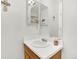 Compact bathroom with a single vanity, decorative mirror, and clean lines maximizing space and functionality at 9774 Burberry Way, Highlands Ranch, CO 80129