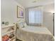 Cozy bedroom with soft lighting, featuring a full bed, bookcase, and neutral color palette creates a calming retreat at 9774 Burberry Way, Highlands Ranch, CO 80129