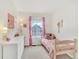 Bright bedroom with pink accents, featuring a twin bed and a dresser creating a charming and inviting space at 9774 Burberry Way, Highlands Ranch, CO 80129
