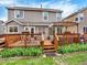 A wooden deck is ready for entertaining and enjoying the outdoor with a seating area at 9774 Burberry Way, Highlands Ranch, CO 80129