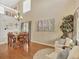 Bright dining area with hardwood floors, high ceilings, and modern chandelier lighting at 9774 Burberry Way, Highlands Ranch, CO 80129