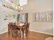 Elegant dining room with hardwood floors, a large chandelier, and an upper-level view at 9774 Burberry Way, Highlands Ranch, CO 80129