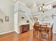 Open dining area featuring hardwood floors, ample seating, and an adjacent staircase at 9774 Burberry Way, Highlands Ranch, CO 80129