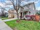 Inviting two-story home with a covered porch, well-maintained lawn, and landscaped front yard at 9774 Burberry Way, Highlands Ranch, CO 80129
