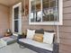 Cozy front porch with a welcoming porch swing and decorative floral wreath on the front door at 9774 Burberry Way, Highlands Ranch, CO 80129