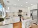 Bright kitchen featuring white cabinets, granite countertops, and stainless steel appliances at 9774 Burberry Way, Highlands Ranch, CO 80129