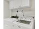 Bright laundry room features appliances and ample storage space at 9774 Burberry Way, Highlands Ranch, CO 80129