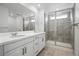 Bright bathroom featuring a double sink vanity, glass shower, and neutral paint at 39713 Penn Rd, Elizabeth, CO 80107