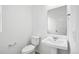 Bathroom with white sink, toilet, and neutral paint at 39713 Penn Rd, Elizabeth, CO 80107