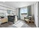 Bedroom featuring a black crib, stylish decor, and a comfortable rocking chair near the window at 39713 Penn Rd, Elizabeth, CO 80107