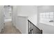 Upstairs hallway with neutral paint, carpet, and white trim at 39713 Penn Rd, Elizabeth, CO 80107