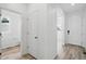 Hallway with white doors, neutral paint, and hardwood floors at 39713 Penn Rd, Elizabeth, CO 80107