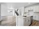 Modern kitchen featuring a bright living space, hardwood floors, and stainless steel appliances at 39713 Penn Rd, Elizabeth, CO 80107