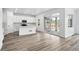 Modern kitchen with stainless steel appliances, white cabinets, and sliding glass doors to the backyard at 39713 Penn Rd, Elizabeth, CO 80107