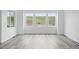 Bright living room featuring hardwood floors and ample natural light from large windows at 39713 Penn Rd, Elizabeth, CO 80107