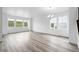 Large living room with hardwood floors and ample natural light at 39713 Penn Rd, Elizabeth, CO 80107