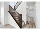 Carpeted staircase with stained handrail in a home with hardwood floors at 39713 Penn Rd, Elizabeth, CO 80107