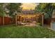 Inviting backyard with a wood pergola, outdoor furniture, and manicured lawn perfect for outdoor enjoyment at 944 S Euclid Way, Denver, CO 80209