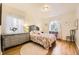 Sunlit bedroom boasts hardwood floors, delicate decor, and ample natural light for a peaceful ambiance at 944 S Euclid Way, Denver, CO 80209